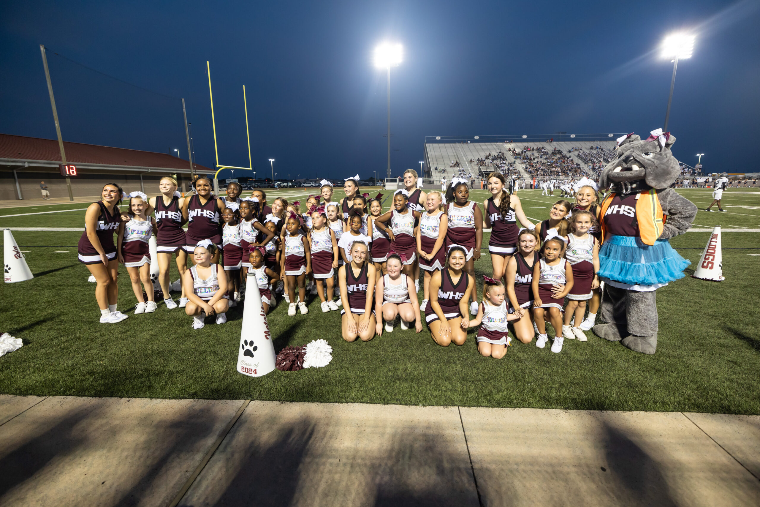 The Waller High School cheerleaders and the Waller PeeWee Football Association cheerleaders group together during the varsity football season opener Friday night. The Waller Bulldog varsity team battles the Bryan Vikings, with the 21-6 decision favoring the Vikings. The Bulldogs next game will be against Mayde Creek in Katy ISD's Legacy Stadium. (photo courtesy RoninVisuals.com)