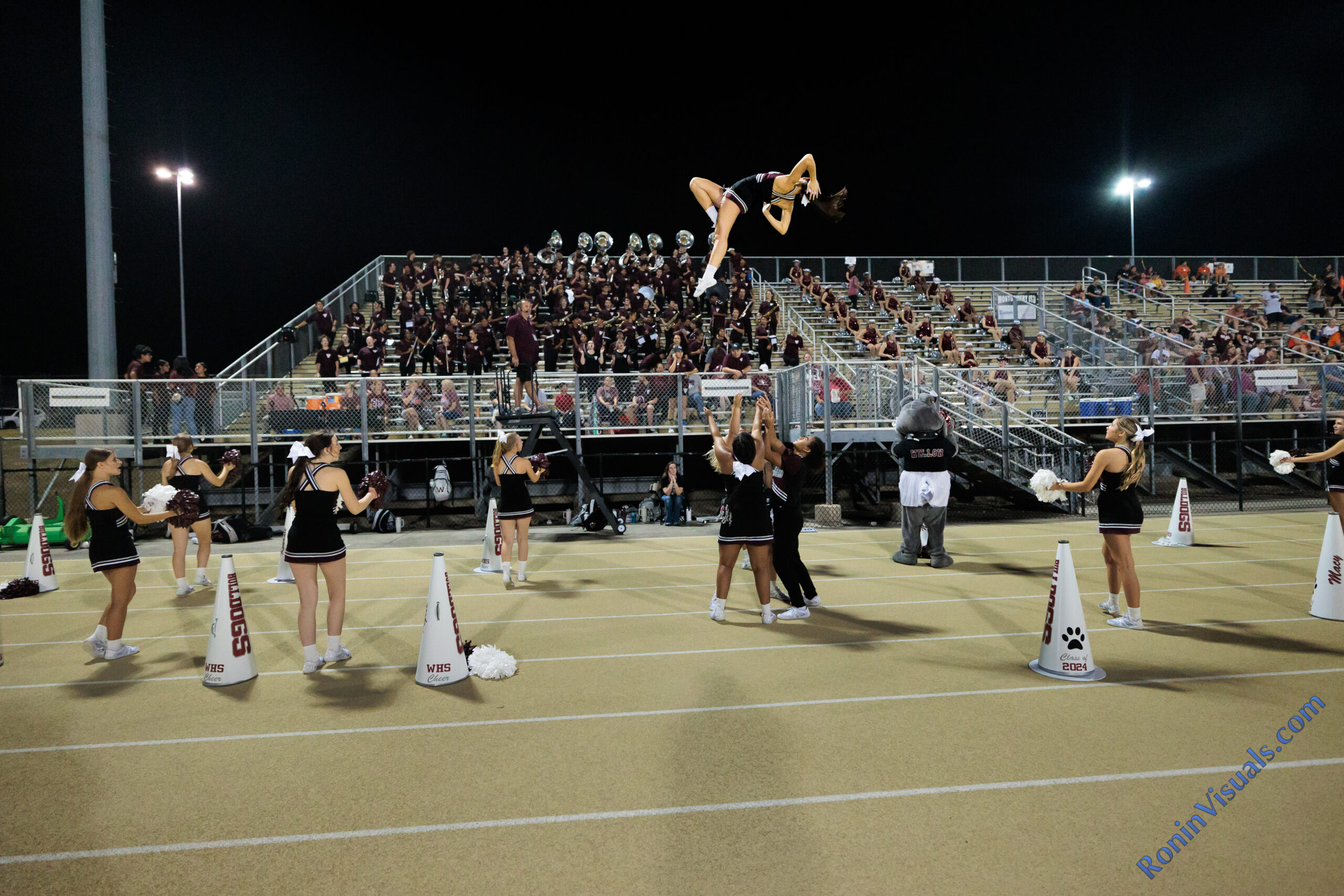 Cheer captain Natalie Barish (midair) performs her "pretty girl" basket toss during the third game of the football season. The Waller Bulldogs got a reality check from one of the top ranked teams in Texas, the Montgomery Lake Creek Lions with a 63-24 decision at Montgomery ISD Athletics Complex, Friday, Sept. 8, 2023. (Photo courtesy RoninVisuals.com)