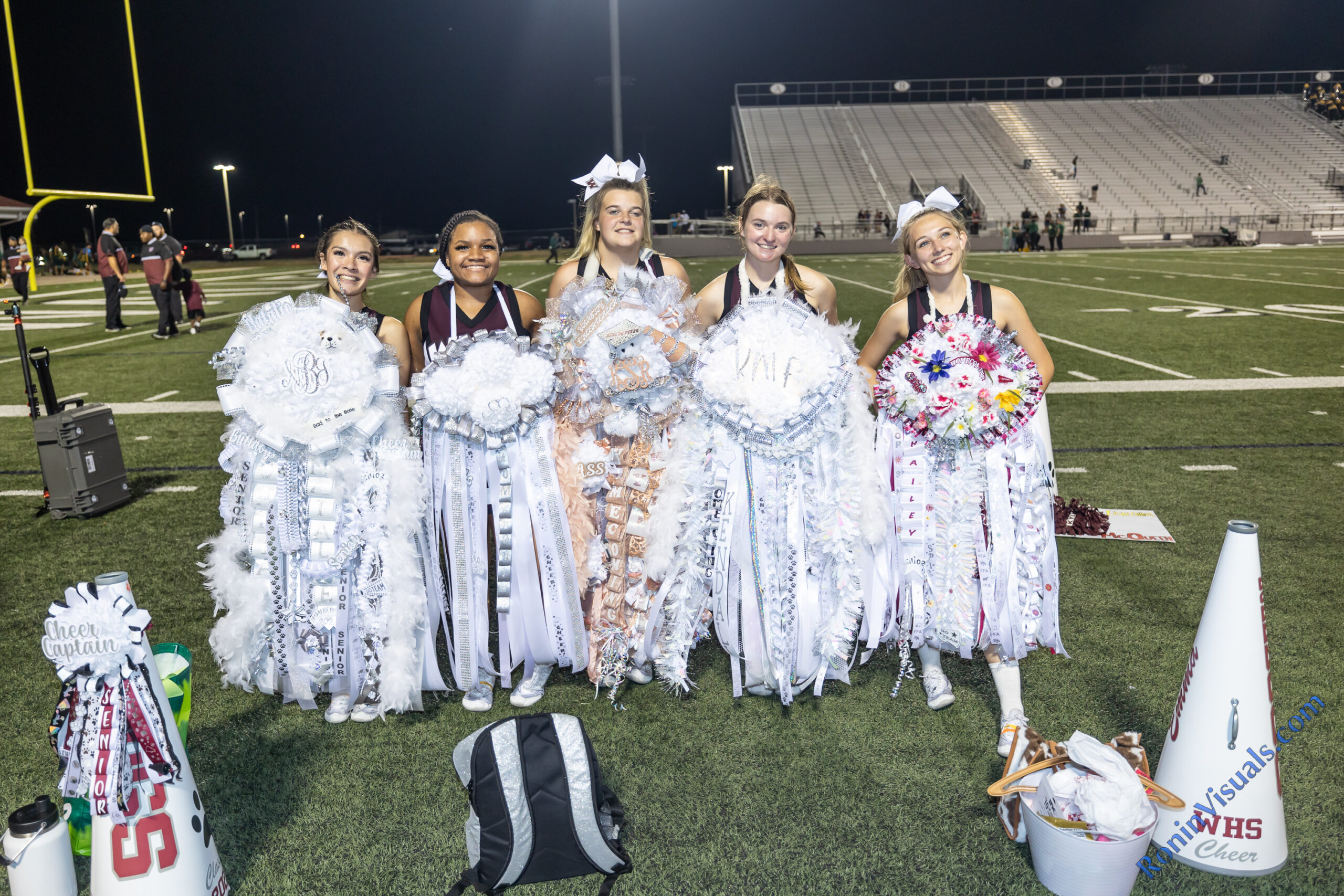 Some of the 2024 Waller cheerleaders show off their giant homecoming mums at Waller ISD Stadium, Friday, Sept. 22, 2023. (Photo courtesy RoninVisuals.com)